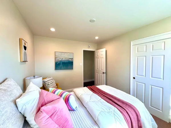 a bedroom with bed and a window