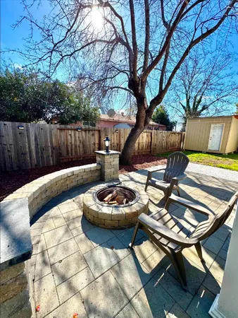 a view of a backyard with swimming pool and furniture