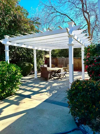 a view of a patio with table and chairs under an umbrella