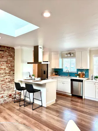 a kitchen with a sink cabinets and wooden floor