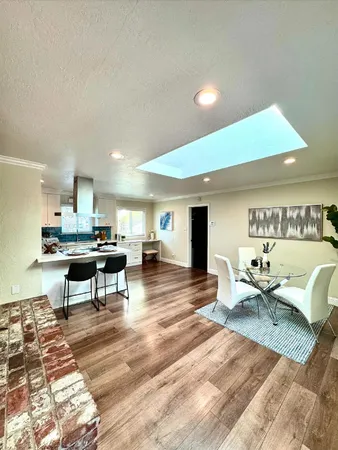 a living room with lots of furniture and view of kitchen