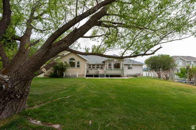 875 East 1300th Street North Mapleton, UT 84664 - Photo 50 of 65 Rear view of house featuring a wooden deck and a lawn