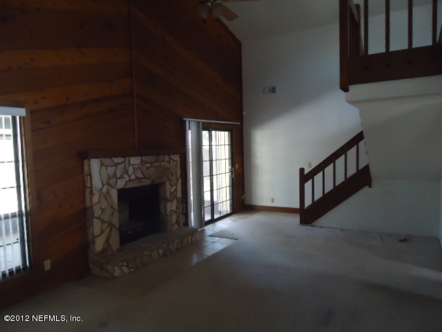 2405 Summer Tree Road East Jacksonville, FL 32246 - Photo 3 of 5 a view of an empty room with fireplace and a window