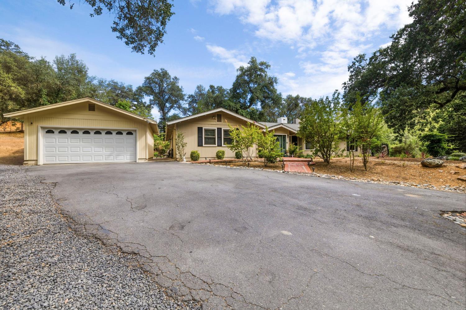 11460 Racetrack Road Sonora, CA 95370 - Photo 4 of 46 a view of large house with a big yard and large trees