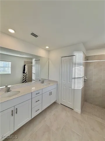 a bathroom with a granite countertop sink mirror and double