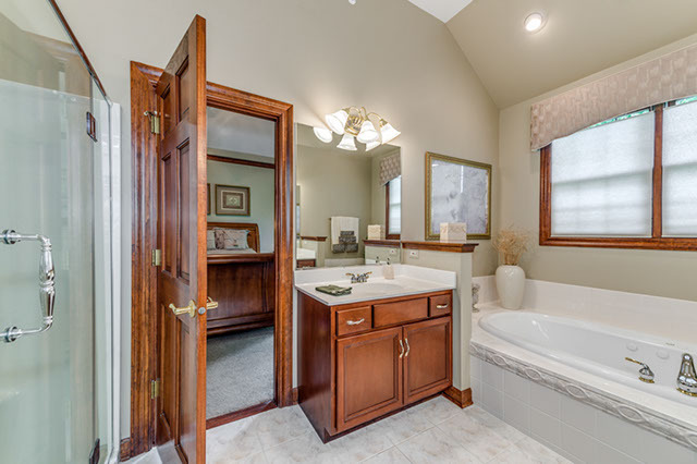 4N446 School Road St. Charles, IL 60175 - Photo 13 of 25 a bathroom with a granite countertop sink a bathtub and a mirror