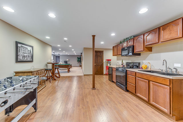 4N446 School Road St. Charles, IL 60175 - Photo 17 of 25 a kitchen with stainless steel appliances granite countertop a refrigerator a sink dishwasher a stove and white countertops with wooden floor