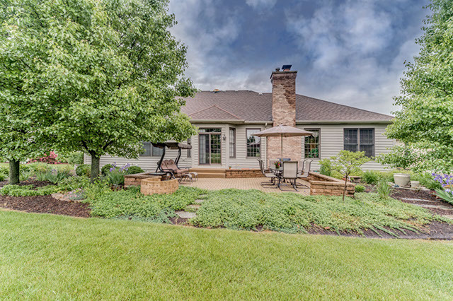 4N446 School Road St. Charles, IL 60175 - Photo 24 of 25 a front view of a house with a garden and sitting area