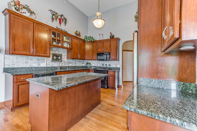 4N446 School Road St. Charles, IL 60175 - Photo 9 of 25 a kitchen with stainless steel appliances granite countertop a sink a stove and a wooden cabinets