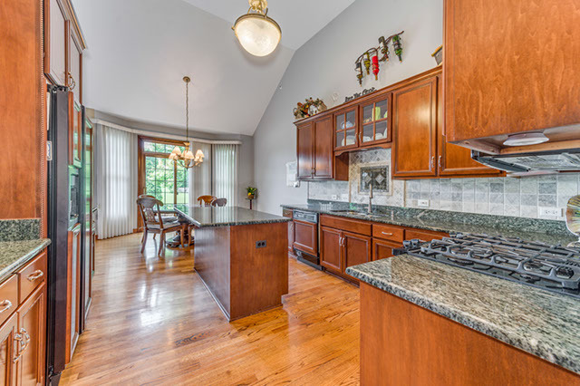 4N446 School Road St. Charles, IL 60175 - Photo 10 of 25 a kitchen with stainless steel appliances granite countertop sink stove top oven and cabinets