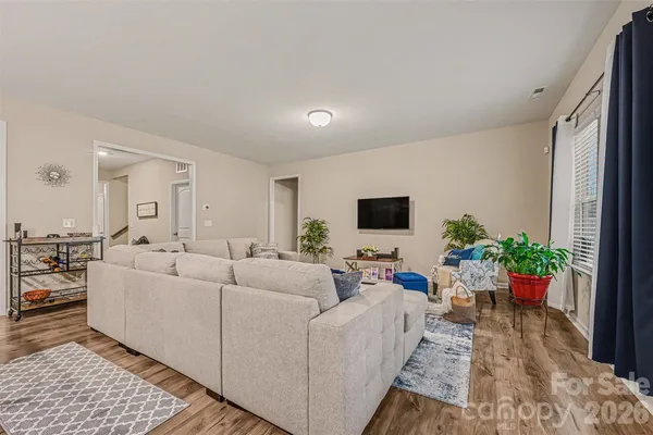 a living room with furniture potted plant and a window