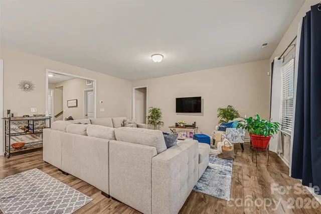 a living room with furniture potted plant and a window