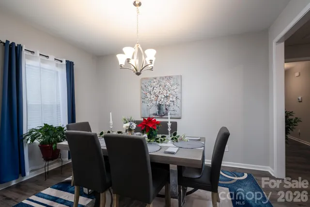 a view of a dining room with furniture wooden floor and a chandelier
