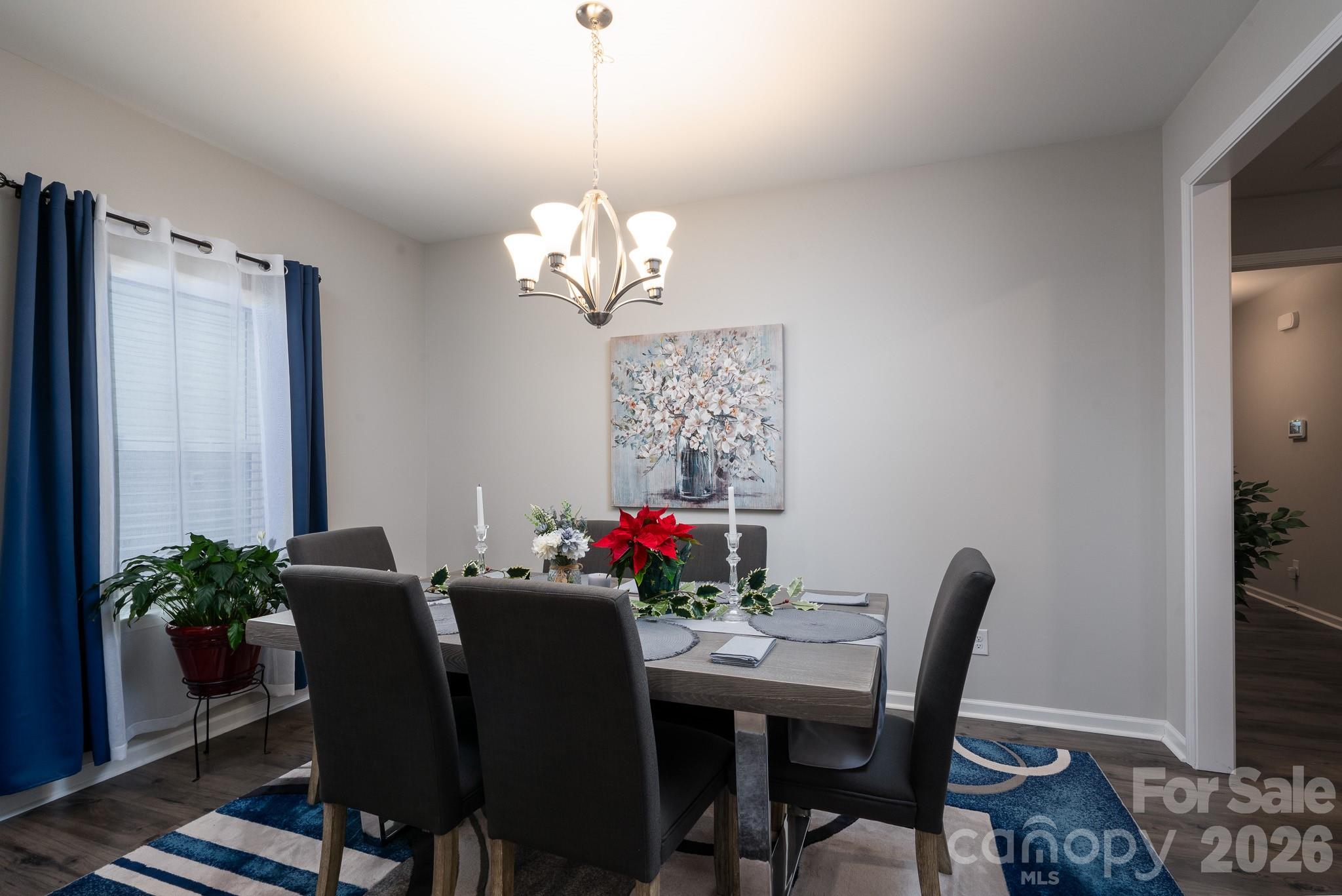 1772 Savannah Lane, Unit 19 Stanfield, NC 28163 - Photo 14 of 29 a view of a dining room with furniture wooden floor and a chandelier