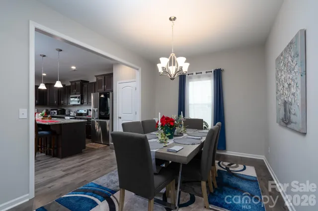 a view of a dining room with furniture and chandelier