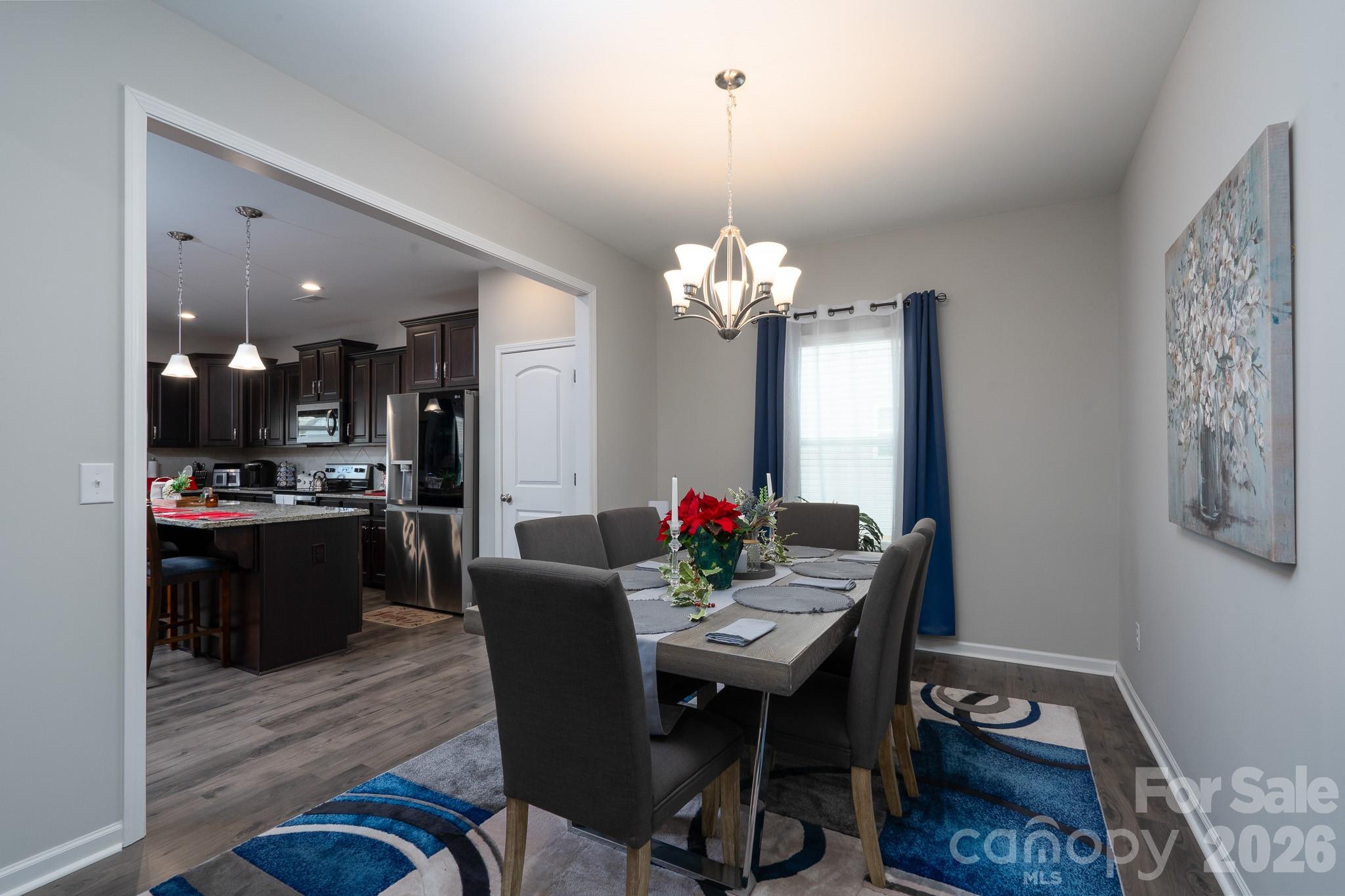 1772 Savannah Lane, Unit 19 Stanfield, NC 28163 - Photo 15 of 29 a view of a dining room with furniture and chandelier
