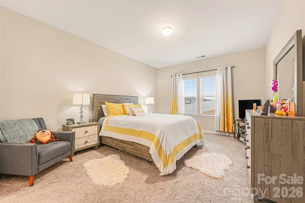 a spacious bedroom with a bed and a couch