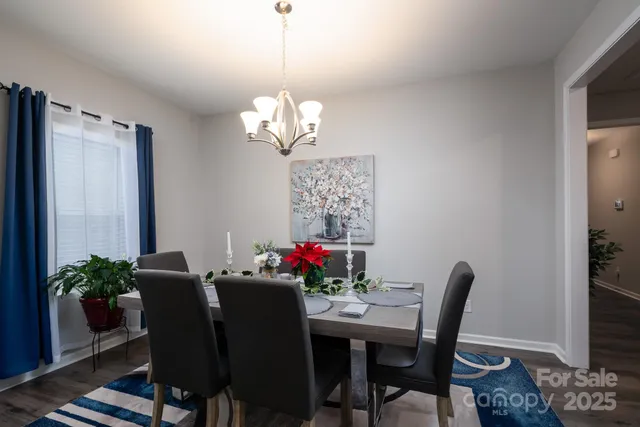 a view of a dining room with furniture wooden floor and a chandelier