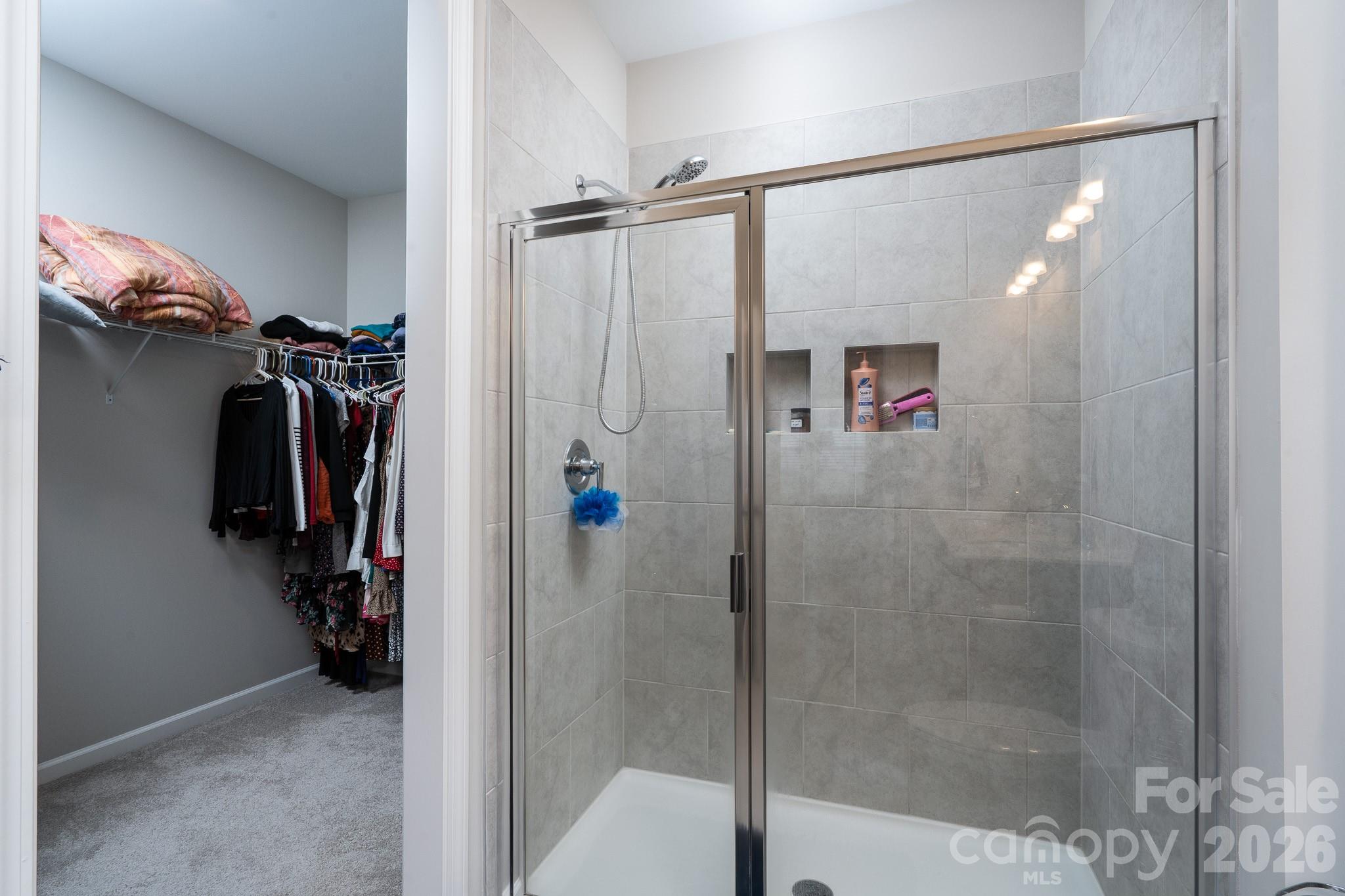 1772 Savannah Lane, Unit 19 Stanfield, NC 28163 - Photo 20 of 29 a view of walk in closet with clothes and shoes