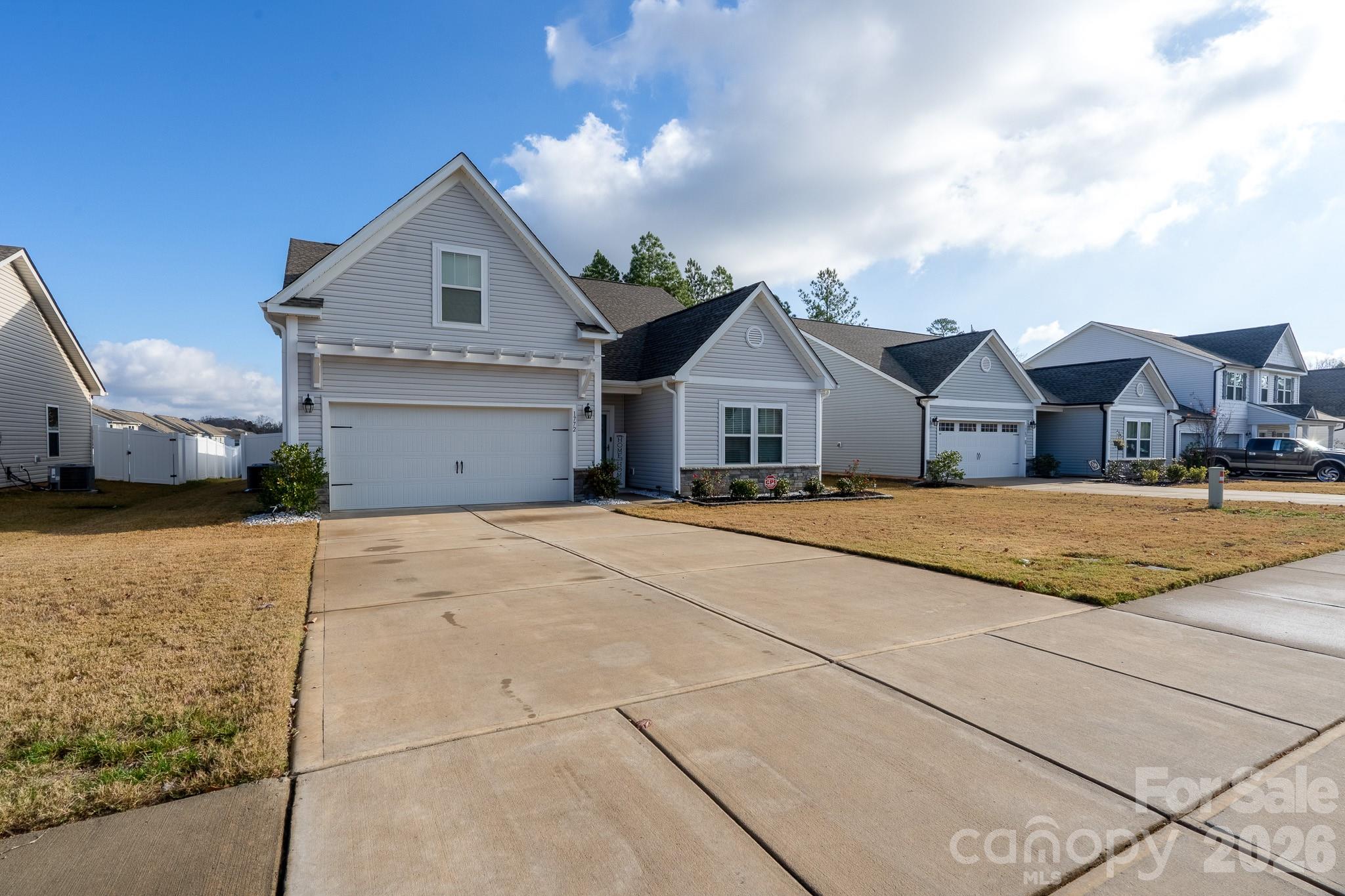 1772 Savannah Lane, Unit 19 Stanfield, NC 28163 - Photo 2 of 29 a view of house with yard street and car parked