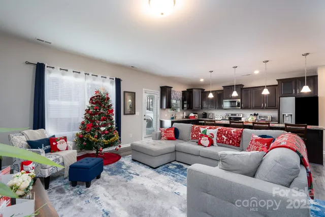 a living room with furniture and kitchen view