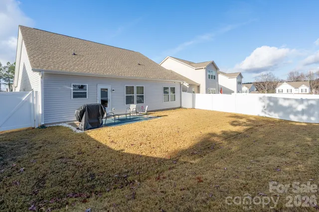 a house view with swimming pool in front of it