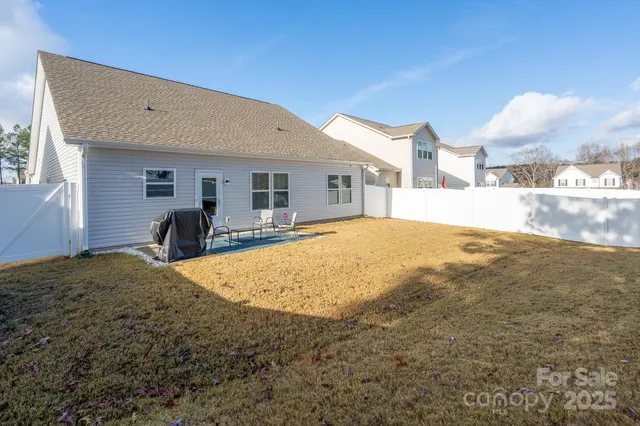 a view of a house with a backyard
