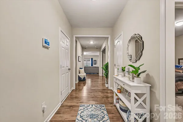 a hallway with painting and a potted plant