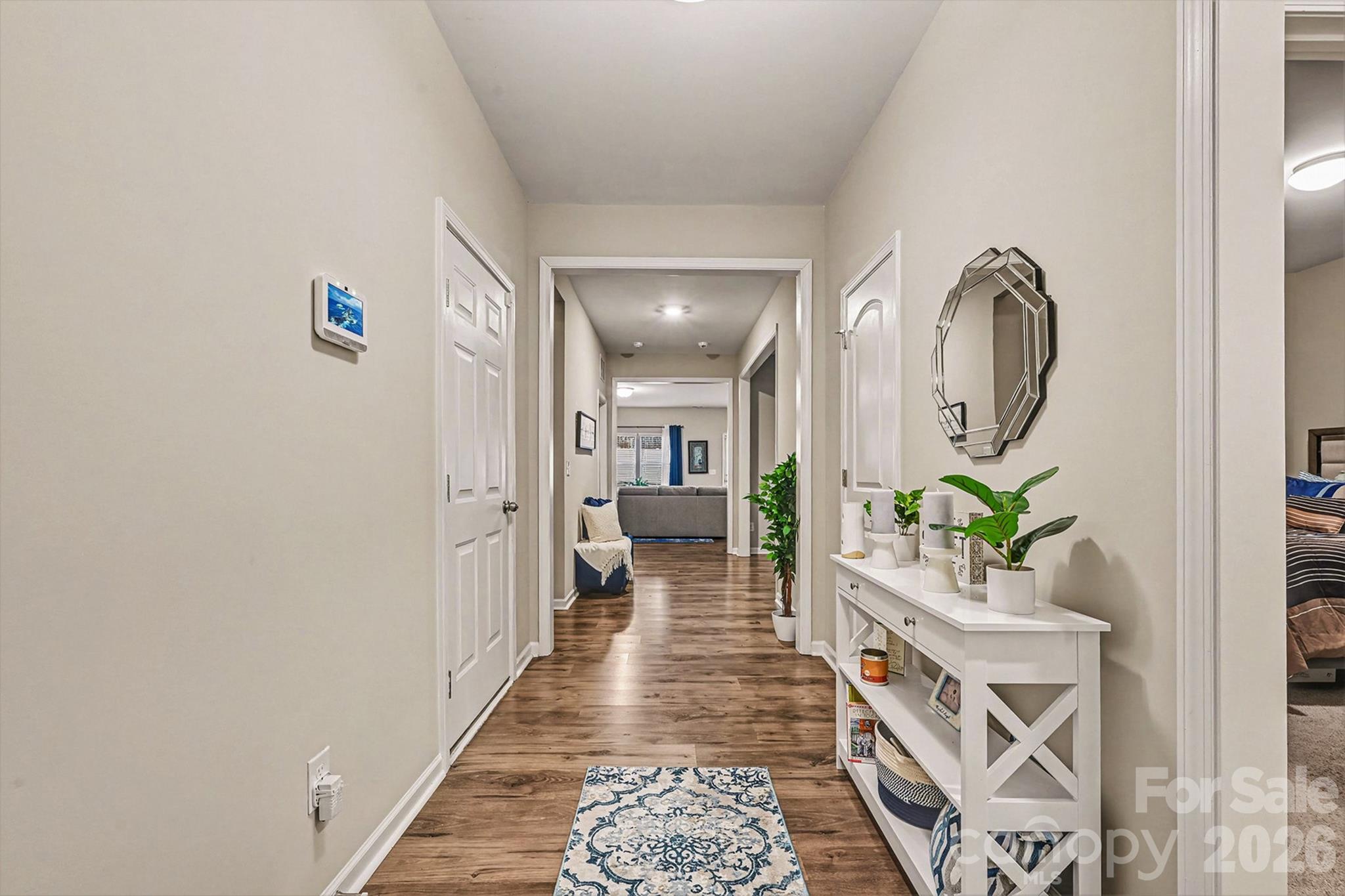 1772 Savannah Lane, Unit 19 Stanfield, NC 28163 - Photo 6 of 29 a hallway with painting and a potted plant