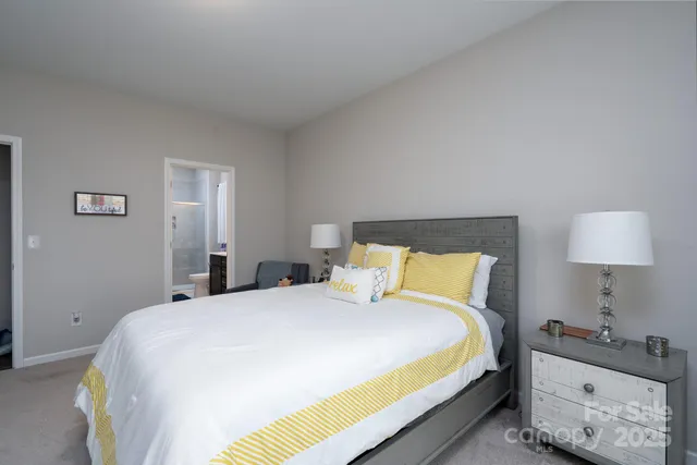 a bedroom with a bed and a lamp