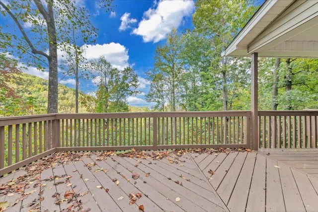 a view of balcony with wooden floor and fence