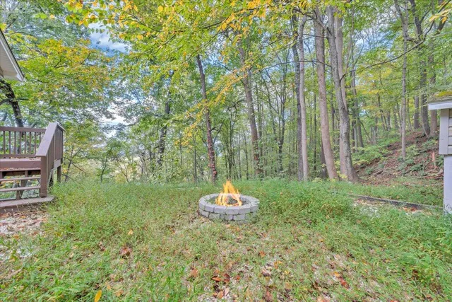 a backyard of a house with a table and chairs