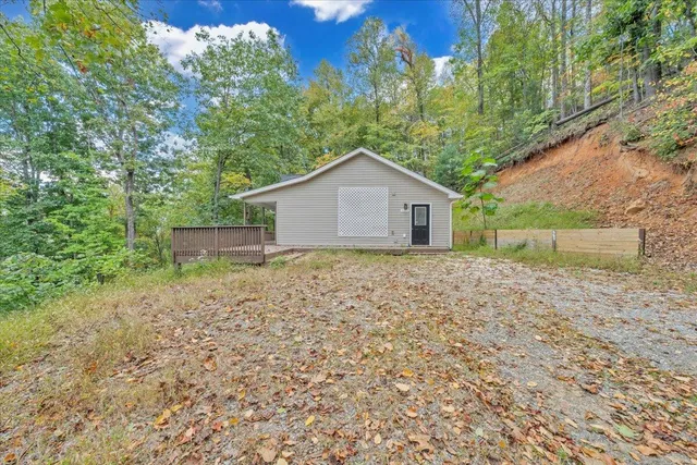 a white house that has a tree in the background