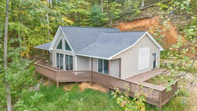front view of house with a yard and deck