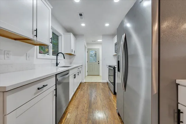 a kitchen with cabinets and stainless steel appliances