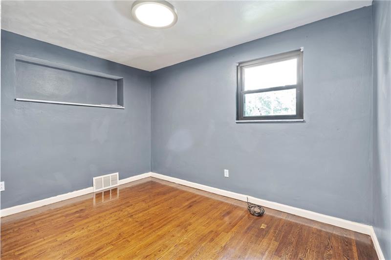308 Frazier Drive Pittsburgh, PA 15235 - Photo 15 of 29 a view of an empty room with wooden floor and a window