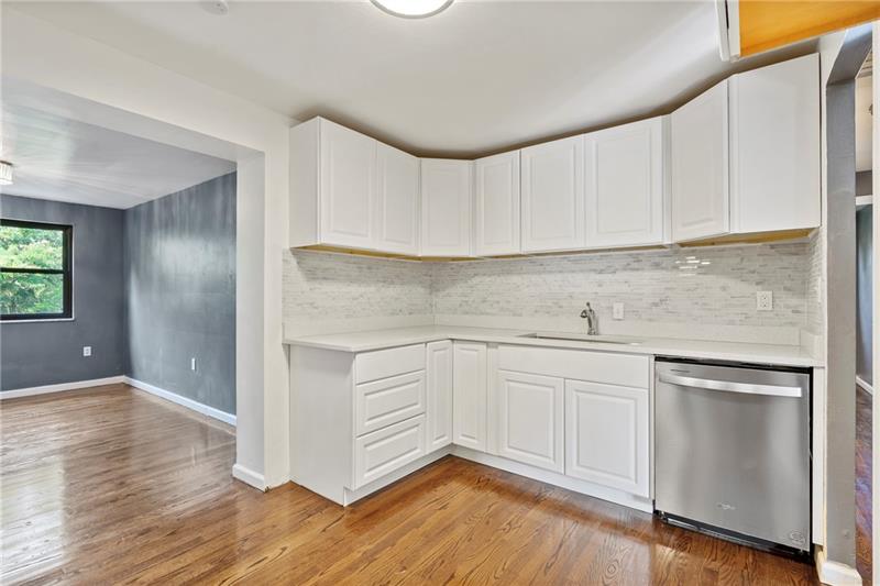 308 Frazier Drive Pittsburgh, PA 15235 - Photo 8 of 29 a kitchen with granite countertop white cabinets and white appliances