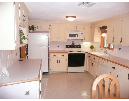 18 Governor Fuller Road Billerica, MA 01821 - Photo 6 of 30 a kitchen with stainless steel appliances a stove a sink cabinets and a refrigerator