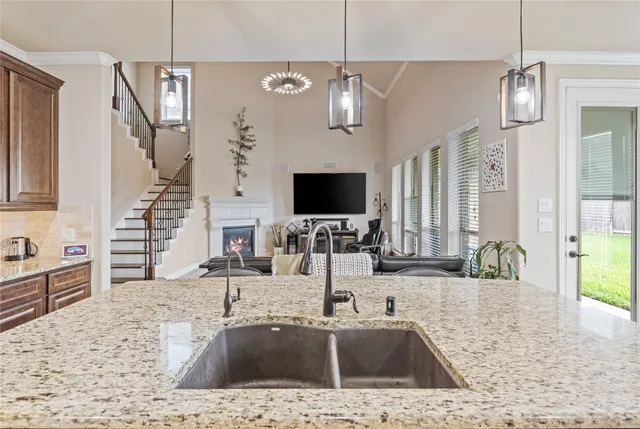 a view of a kitchen with a sink and a chandelier
