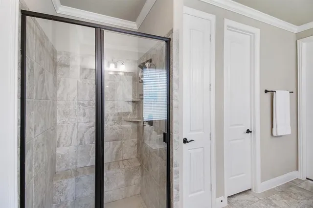 a bathroom with a glass shower door