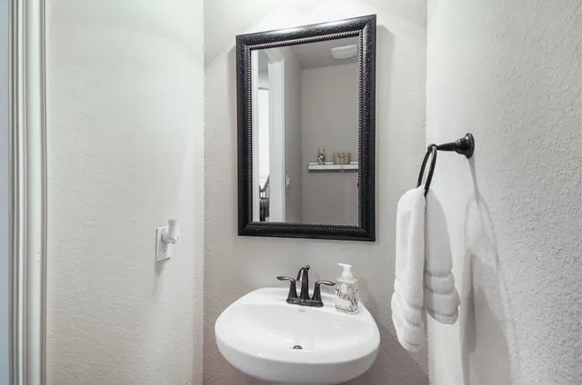 a view of a livingroom with wooden floor and a flat screen tv