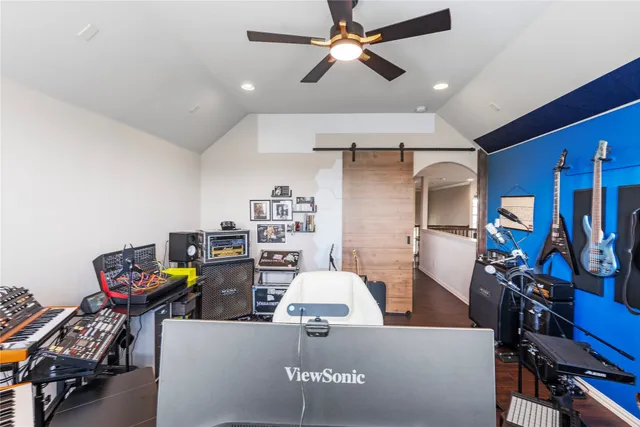 a view of a workspace with furniture and a ceiling fan