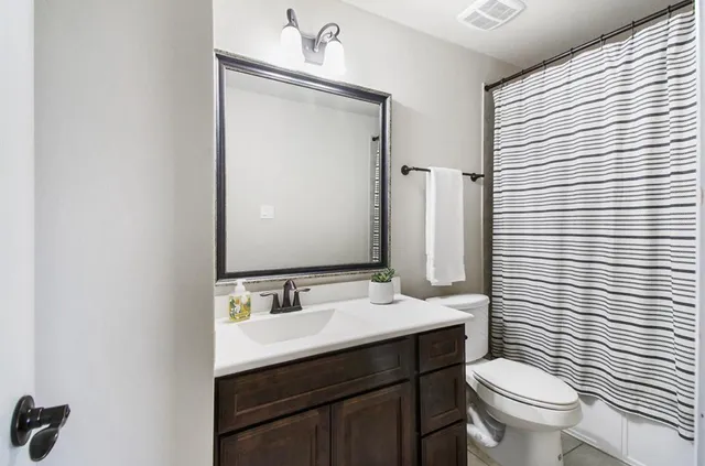 a spacious bedroom with a bed and a flat screen tv