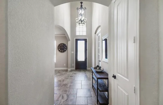 a view of a hallway with entryway wooden floor and front door