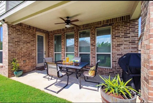 a view of a house with a yard and sitting area