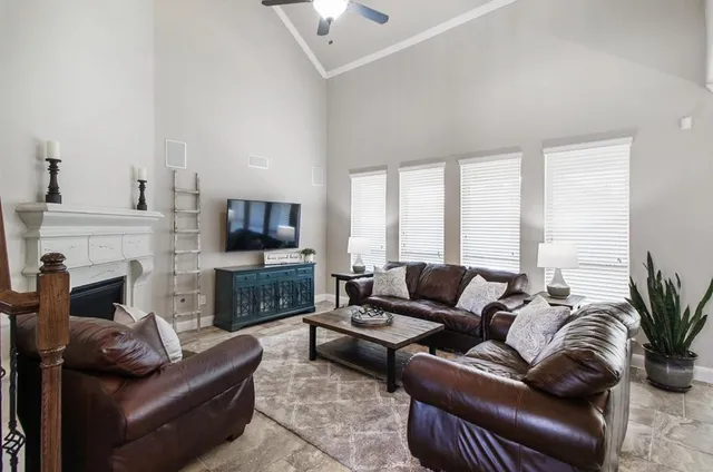 a living room with furniture a flat screen tv and a fireplace
