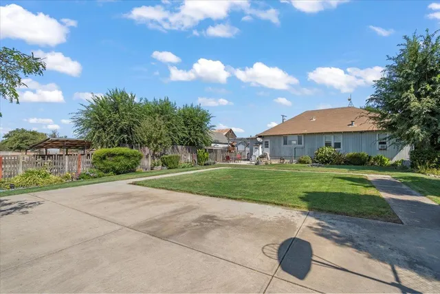 a view of a street with a big yard