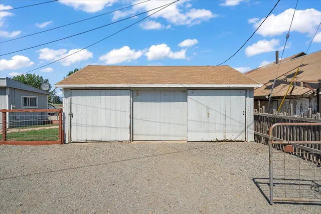a view of house with garage and chair