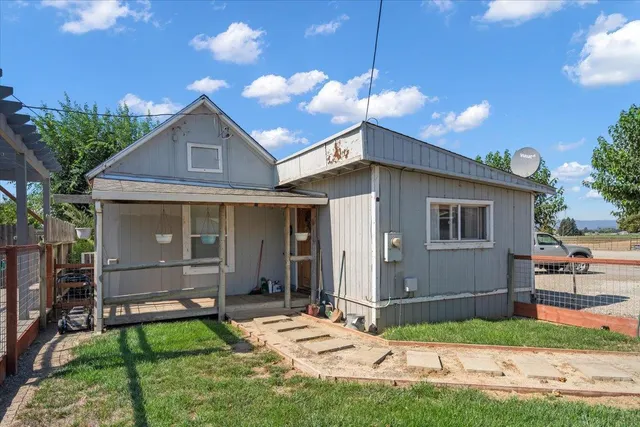 a view of a house with backyard porch and sitting area
