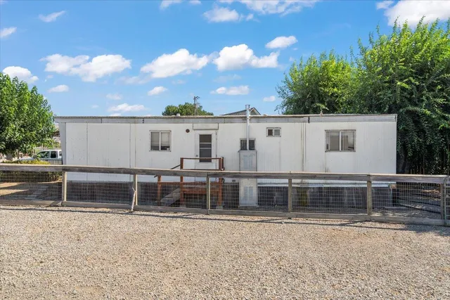 a roof deck with table and chairs